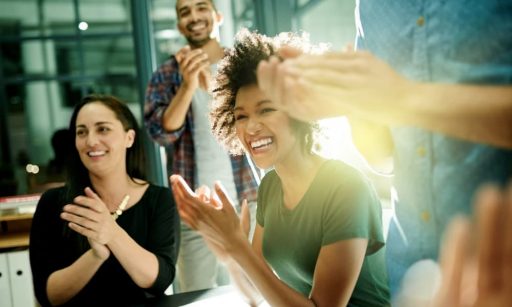 a team of happy BDMs celebrating success at work