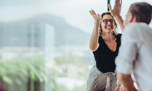 A property manager enthusiastically high-fives a colleague