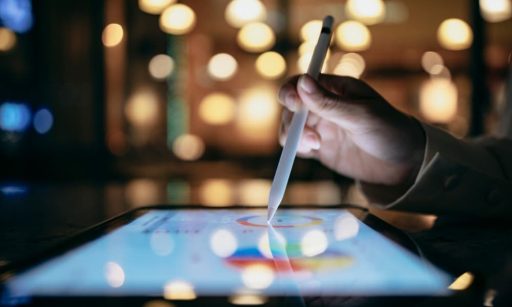 A property management professional using a tablet for forecasting