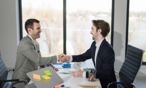 two business people shaking hands after a closing