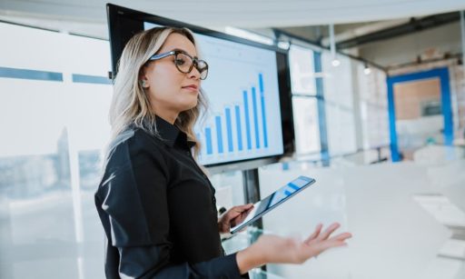 an employee presenting a data-driven process design in a conference room