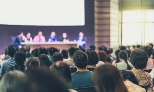 People sitting in the audience at a property management conference.