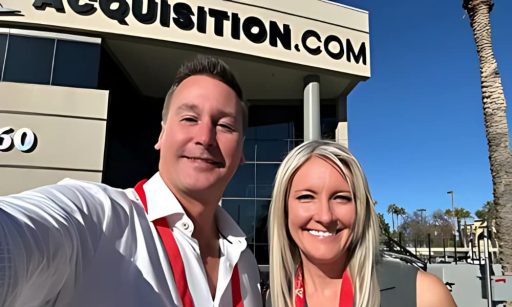 Two property managers, Jen & Jeremy, pose for a selfie in front of the Acquisition.com building during the daytime.