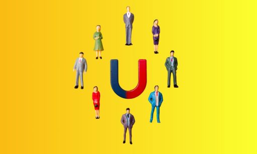 Models of people arranged around a magnet on a yellow background.