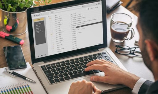 A property manager sitting at his laptop, working on improving his newsletter.
